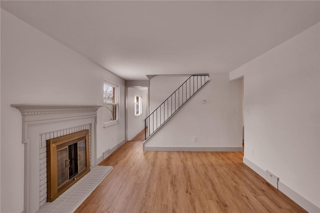 unfurnished living room with light hardwood / wood-style flooring and a fireplace