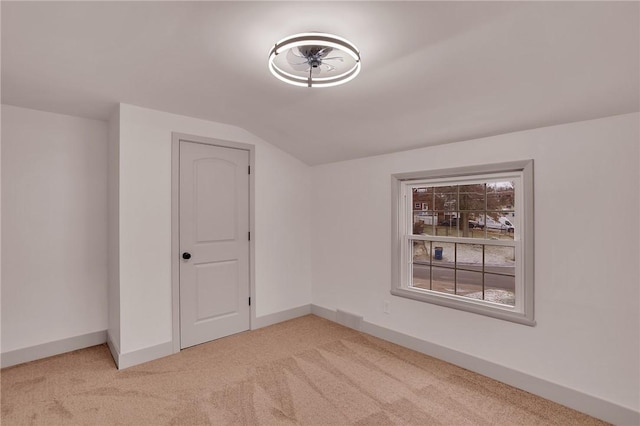 additional living space featuring lofted ceiling and carpet floors