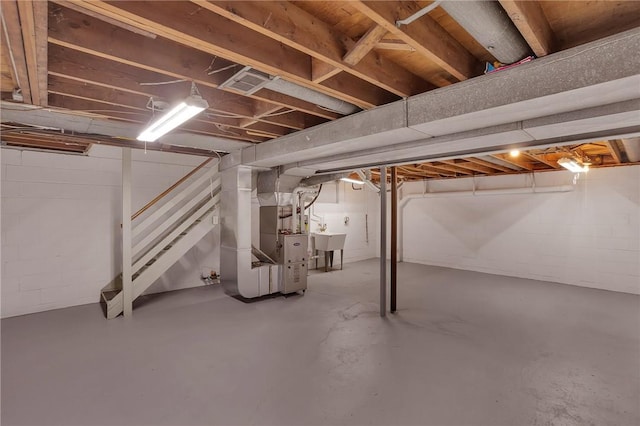 basement featuring heating unit and sink