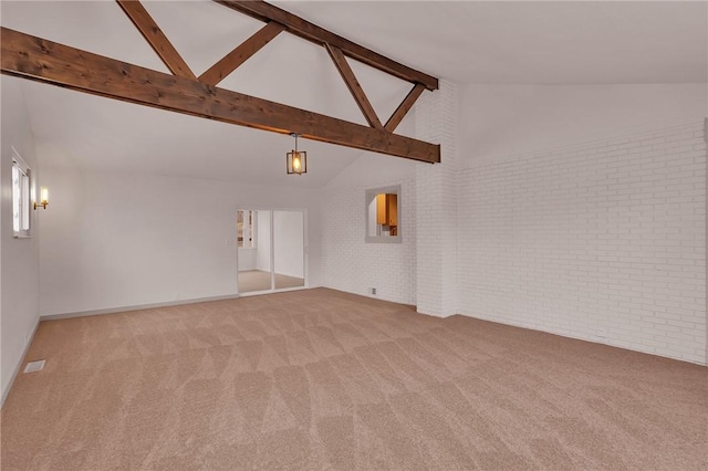 unfurnished living room with high vaulted ceiling, light carpet, brick wall, and beamed ceiling