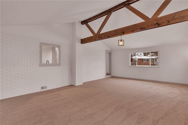 unfurnished living room with carpet, brick wall, beam ceiling, and high vaulted ceiling