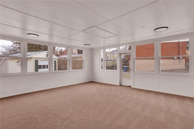 unfurnished sunroom with a drop ceiling