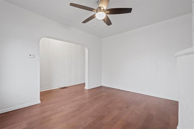 spare room with ceiling fan and wood-type flooring