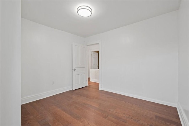 empty room with hardwood / wood-style flooring