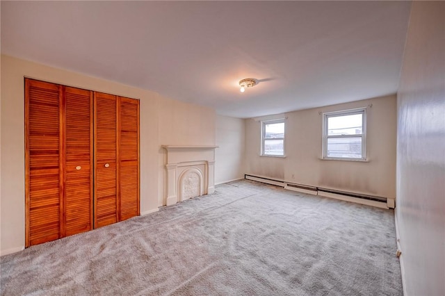 unfurnished living room with a baseboard radiator and light colored carpet