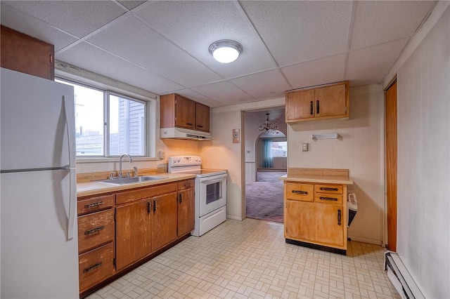 kitchen with a drop ceiling, sink, white appliances, and baseboard heating