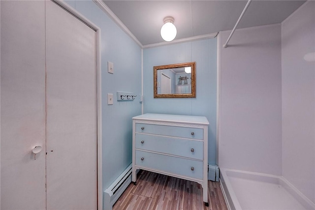 interior space featuring baseboard heating and light hardwood / wood-style flooring