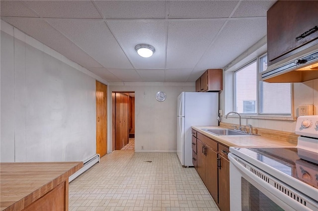 kitchen with white appliances, a baseboard radiator, a drop ceiling, and sink