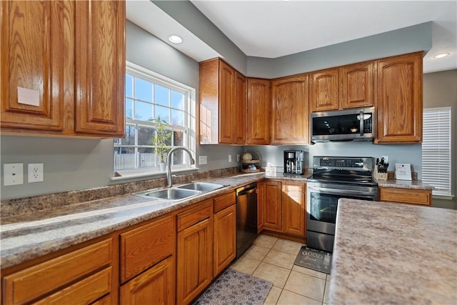 kitchen with light tile patterned floors, stainless steel appliances, and sink