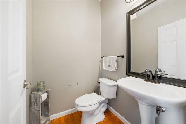 bathroom featuring hardwood / wood-style floors, toilet, and sink