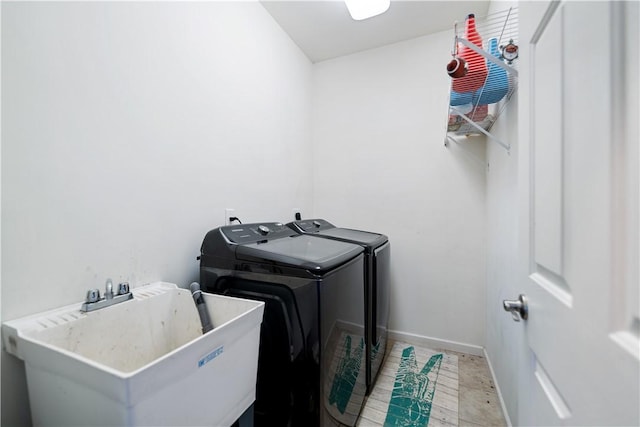 washroom featuring washer and dryer and sink