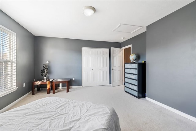 bedroom with light carpet and a closet