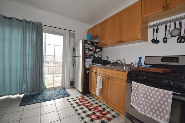 kitchen featuring light tile patterned floors, sink, and appliances with stainless steel finishes