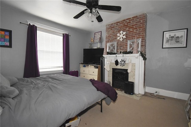 bedroom featuring carpet flooring, ceiling fan, and a brick fireplace