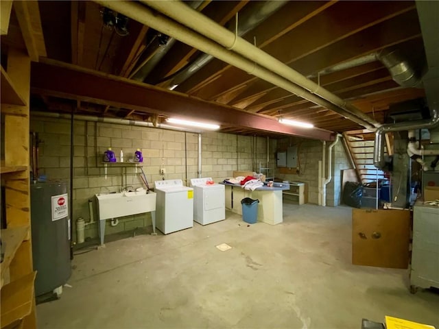 basement with electric panel, water heater, sink, and independent washer and dryer