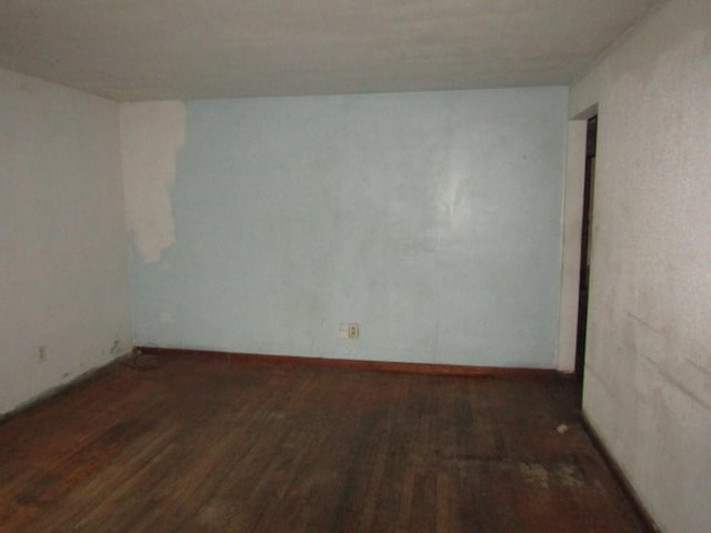 spare room with dark wood-type flooring