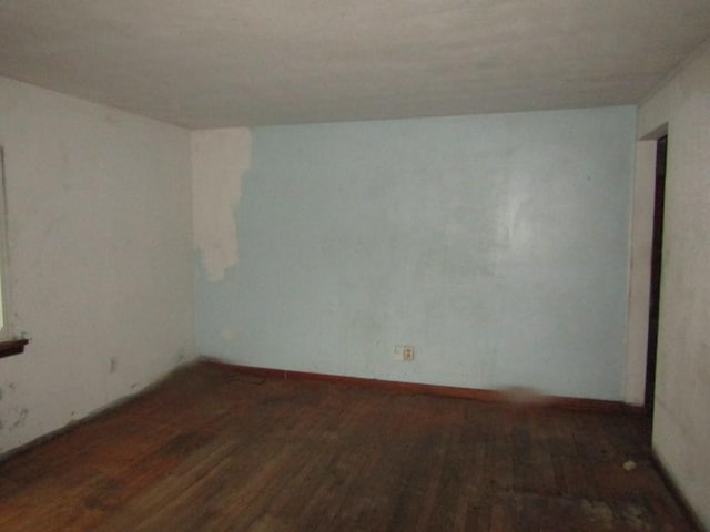 empty room with dark wood-type flooring