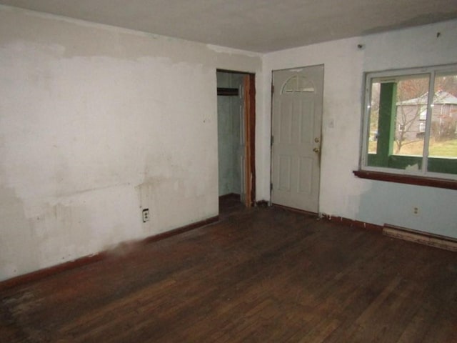 spare room featuring dark wood-type flooring