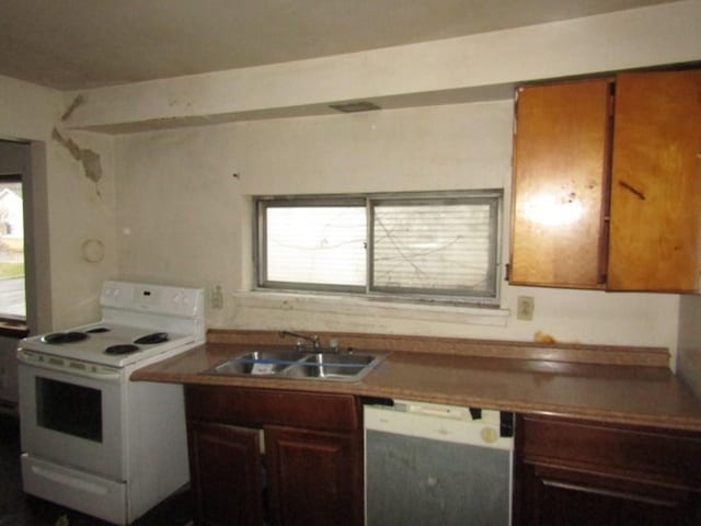 kitchen featuring white appliances and sink