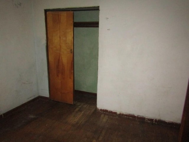 unfurnished room featuring dark hardwood / wood-style floors