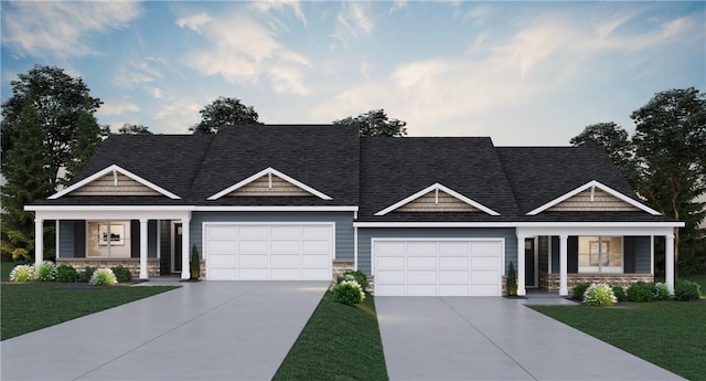 craftsman house with a front yard, a garage, and a porch