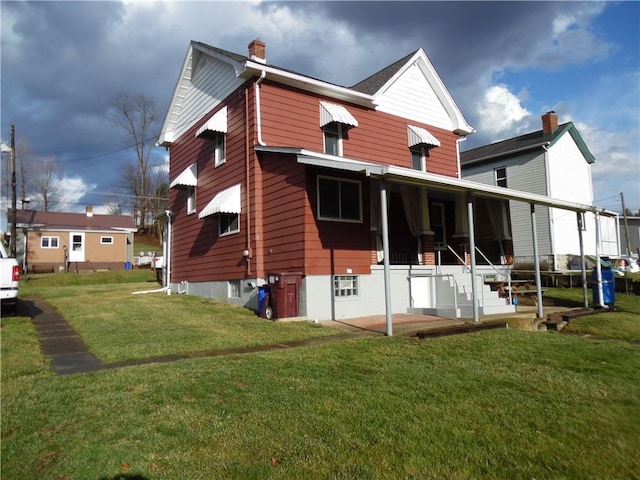 rear view of property with a yard