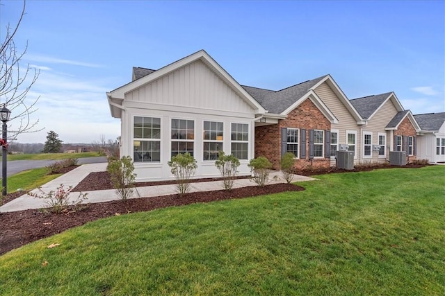 1111 Forest Oaks Dr, Center Twp, PA 16001 - view of front of house featuring board and batten siding, brick siding, a front yard, and a shingled roof
