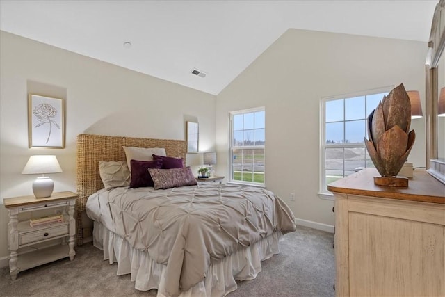 carpeted bedroom featuring high vaulted ceiling