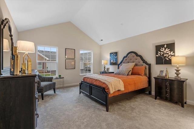 bedroom featuring light colored carpet and lofted ceiling