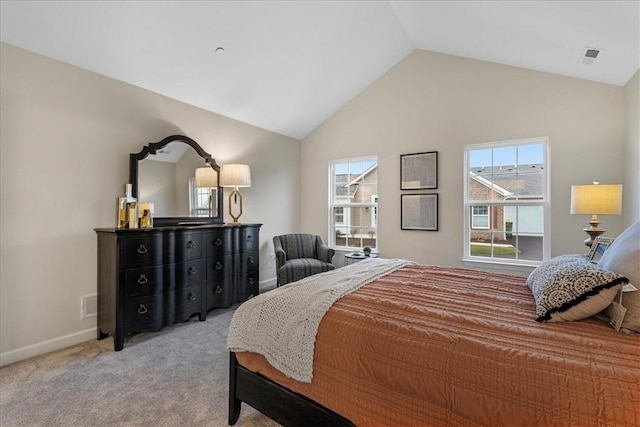 bedroom with light colored carpet and vaulted ceiling