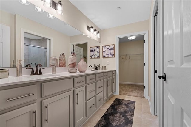 bathroom featuring tile patterned floors, vanity, and an enclosed shower