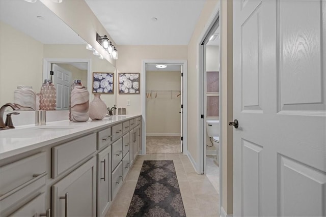 bathroom with tile patterned floors, vanity, and toilet