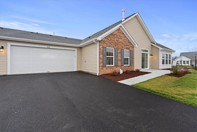 view of front of home with a garage and a front yard