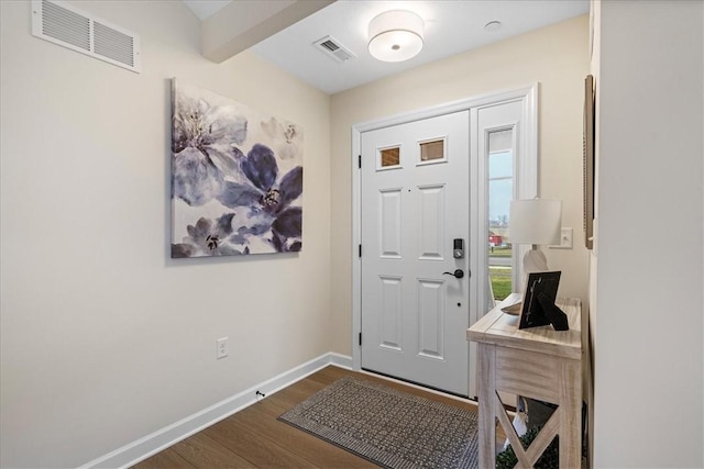 foyer with dark hardwood / wood-style floors and beam ceiling