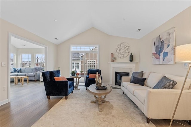 living room with hardwood / wood-style floors and vaulted ceiling