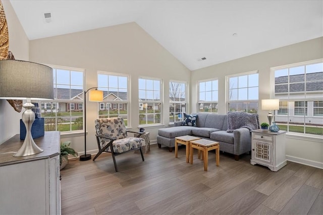 sunroom featuring vaulted ceiling