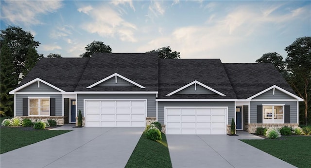 craftsman house featuring a garage and a front lawn