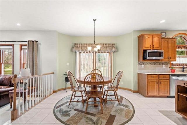 tiled dining space featuring a notable chandelier