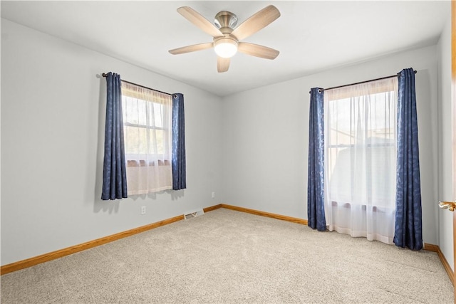 carpeted spare room with ceiling fan