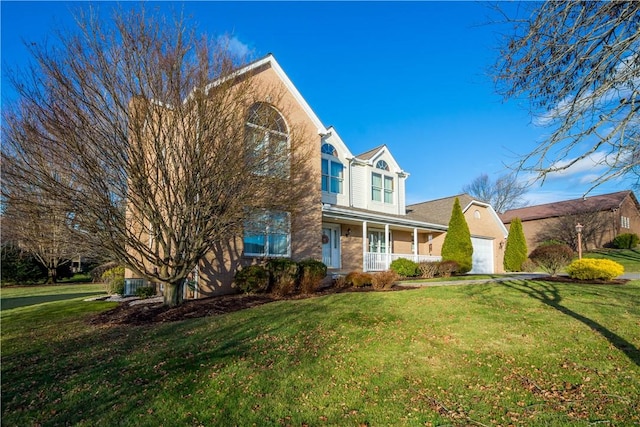 front of property with a front lawn, a porch, and a garage