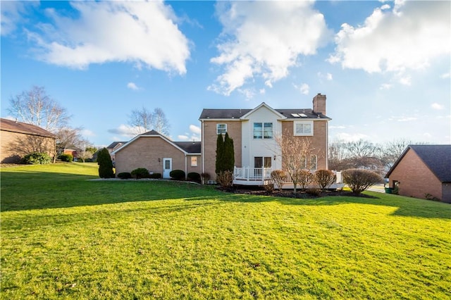 rear view of property featuring a yard