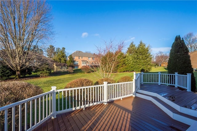 wooden terrace with a lawn