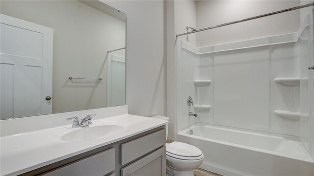 full bathroom with toilet, vanity, and shower / washtub combination