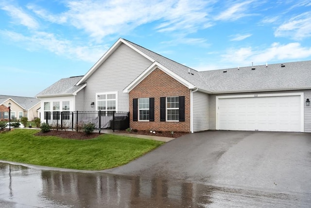 view of front of property featuring a garage and a front lawn