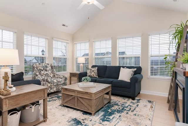 living room featuring light wood-type flooring, ceiling fan, and lofted ceiling