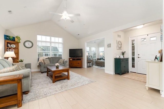 living room with ceiling fan, lofted ceiling, and light wood-type flooring