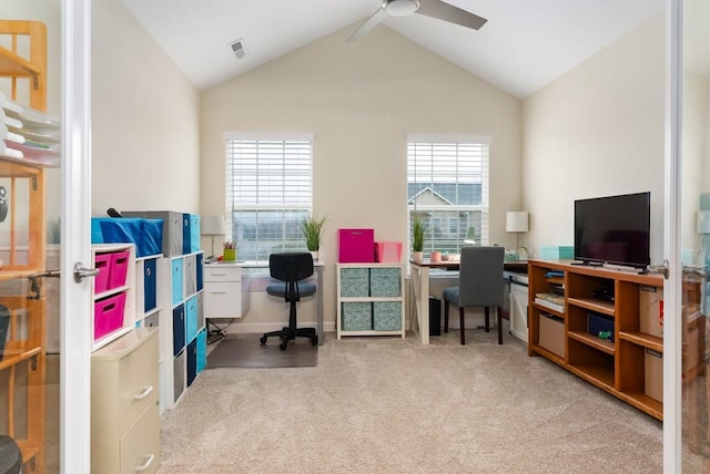 carpeted home office with ceiling fan, lofted ceiling, and a wealth of natural light