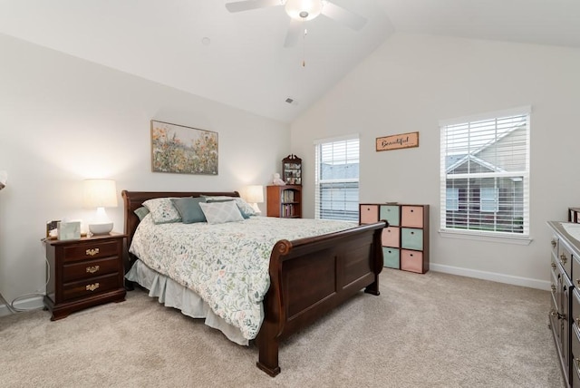 bedroom with ceiling fan, high vaulted ceiling, and light colored carpet