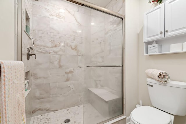 bathroom featuring toilet and walk in shower