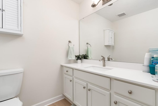 bathroom with vanity and toilet